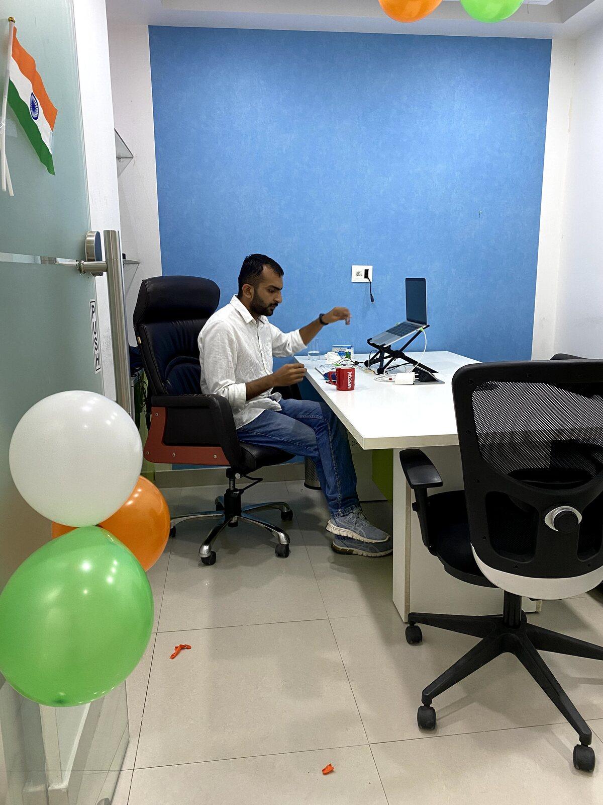 Nivesh working at his desk in the office