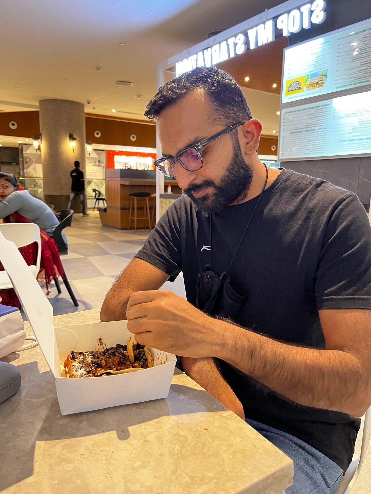 Nivesh enjoying a meal at a food court